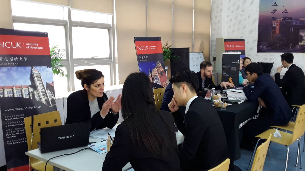 Representatives speak to students at a stop on the tour