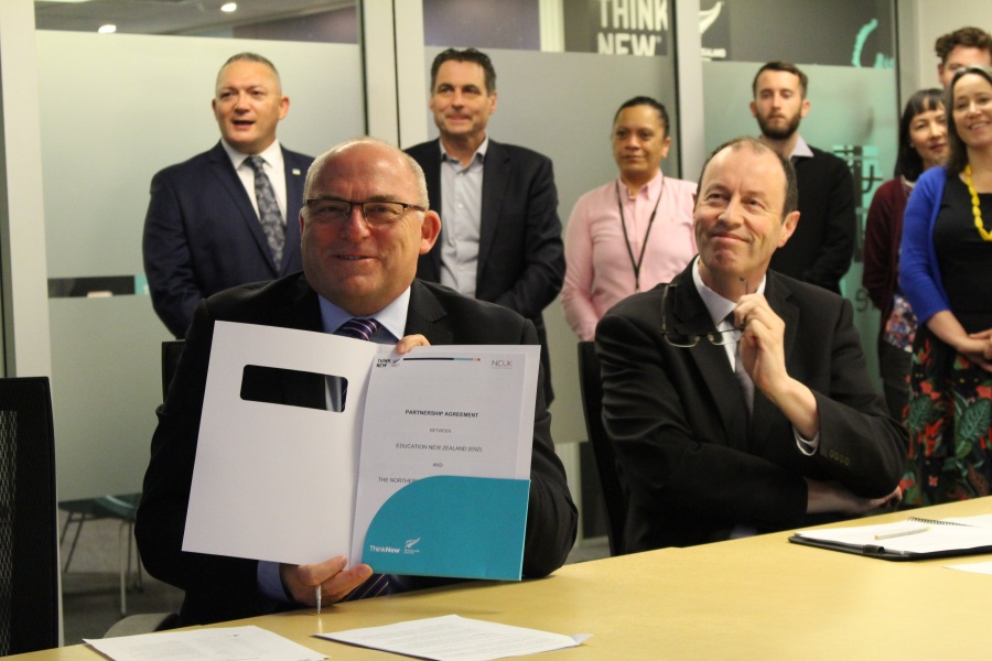Education New Zealand Chief Executive, Grant McPherson (left), and Universities New Zealand, Chief Executive, Chris Whelan, were joined by ENZ staff members in Wellington, New Zealand at the e-signing of the partnership agreement between ENZ and NCUK on 25 November