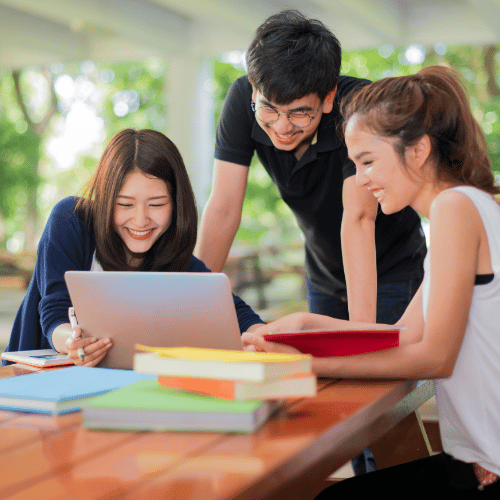 asian students around a laptop