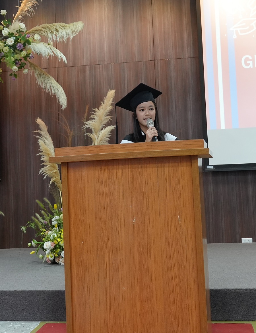Graduate speaking to guests at ceremony.