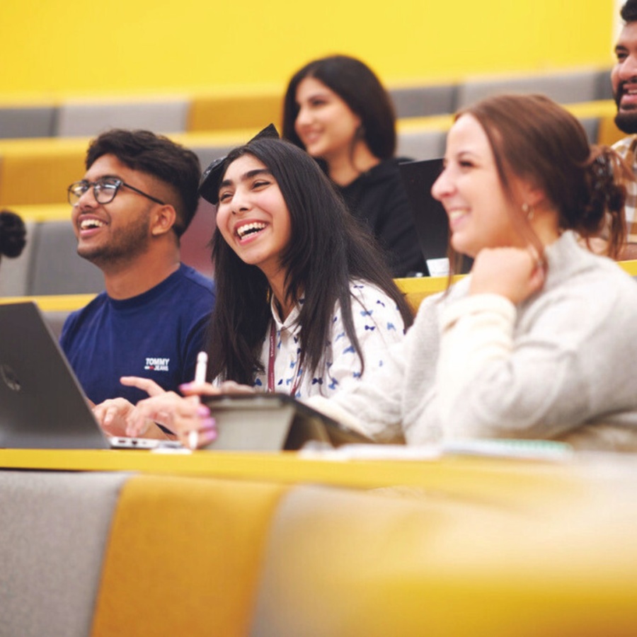 students in lecture theatre smiling