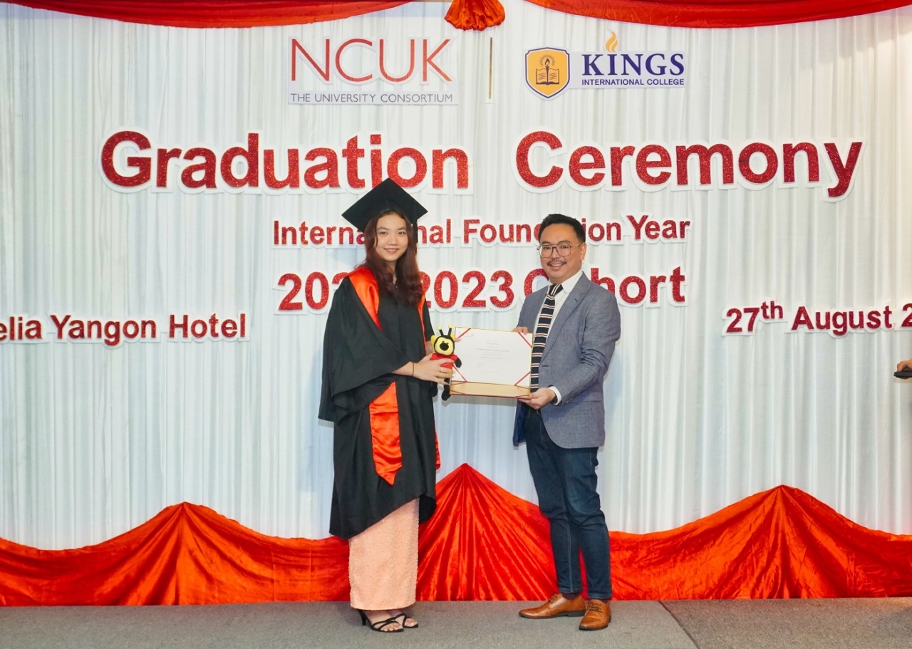 Mr Adrian Ting (Regional Manager of NCUK, East, South-East and South Asia) presenting a certificate to one of KINGS International College's graduating students.