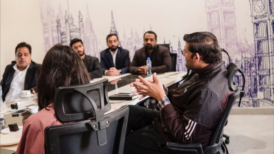 Staff members speaking at table