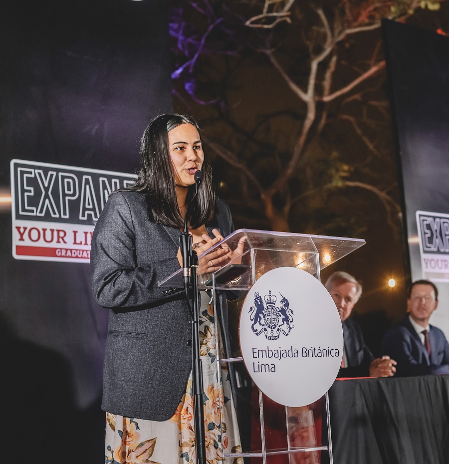 Alumna speaking at graduation ceremony.